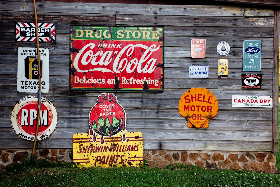 US Free Drug Store Drink Coca Cola Signage on Gray Wooden Wall Stock Photo