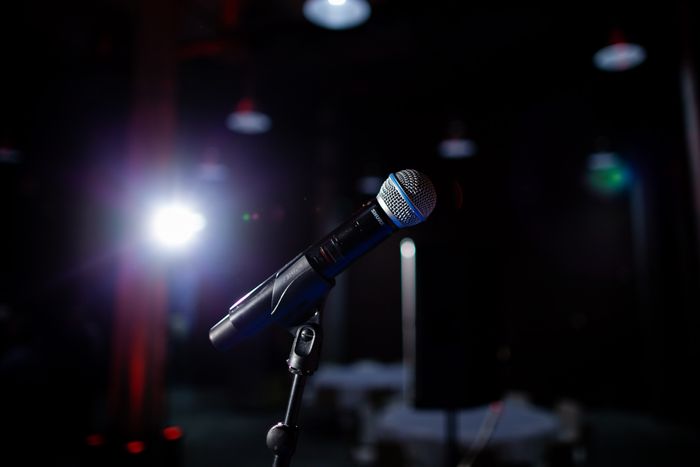 Microphone on a stage under a spotlight — photo by Katrien Grevendonck on Pexels