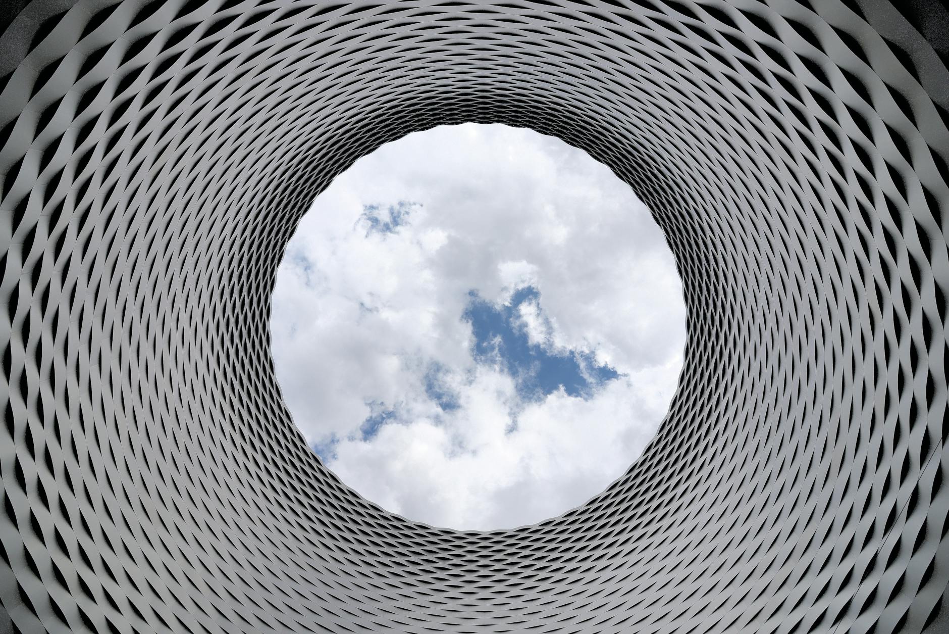 Low-angle Photography of Grey and Black Tunnel Overlooking White Cloudy and Blue Sky