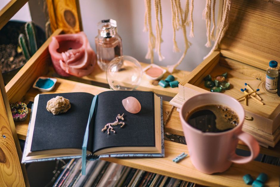Warm and inviting space with coffee, open notebook, and decorative elements.
