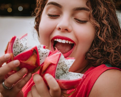 Free Smiling Woman Holding Dragon Fruits Stock Photo