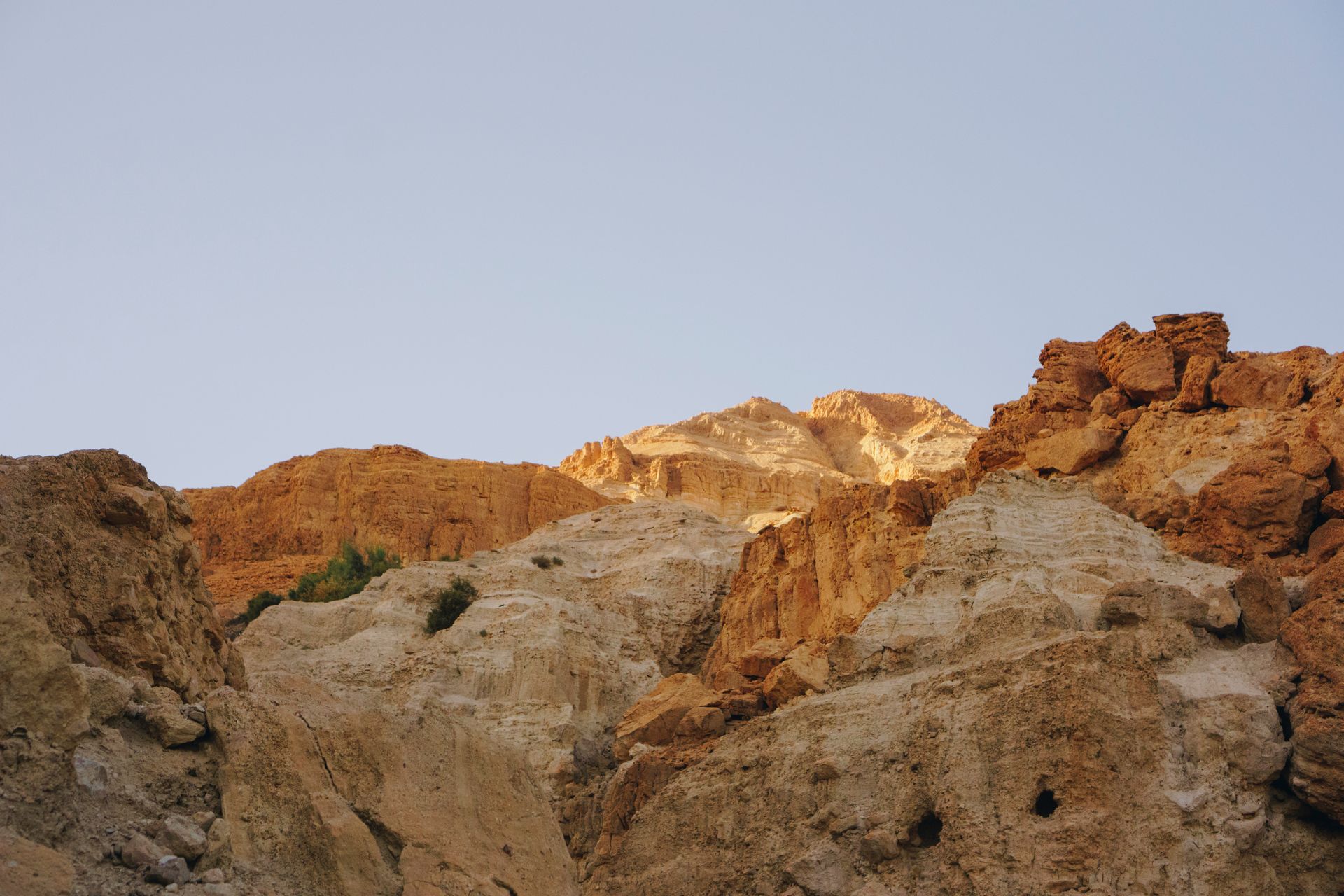 Scenic view of rocky formations under a clear blue sky in Ein Gedi, Israel.