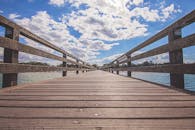 Brown Wooden Pavement Under White Cloudy Sky