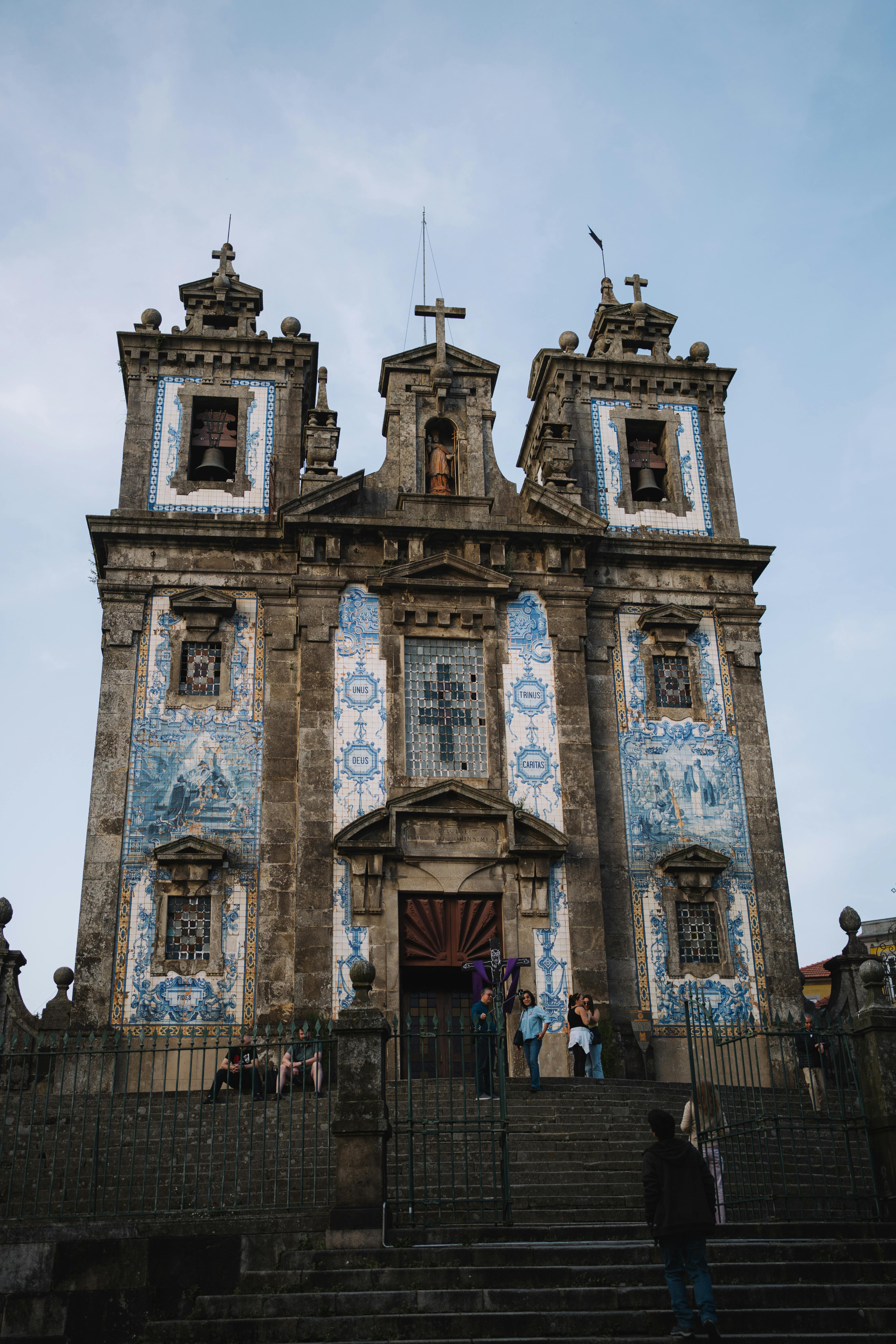 Front view of the ornate St. Ildefonso Church with blue azulejos in Porto, Portugal.
