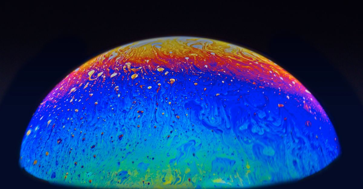 A colorful abstract sphere resembling a planet with swirling cosmic patterns and vibrant hues.