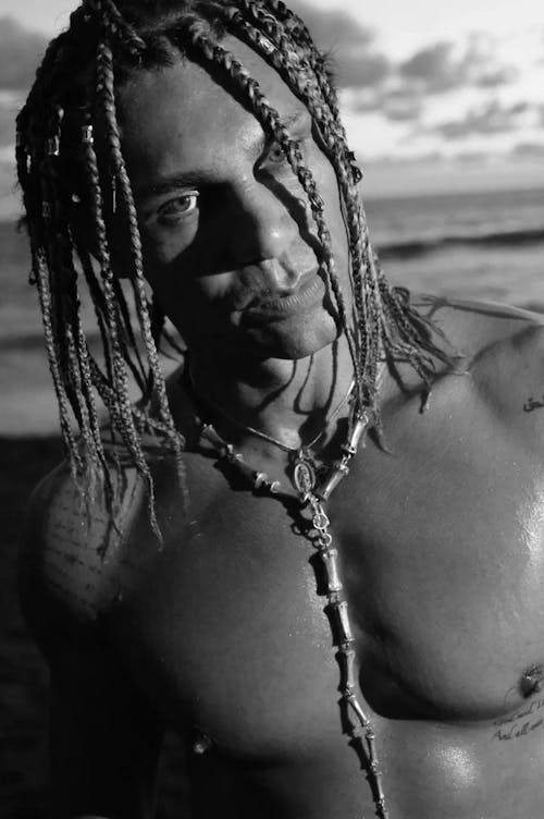 A man with dreadlocks on his chest and neck