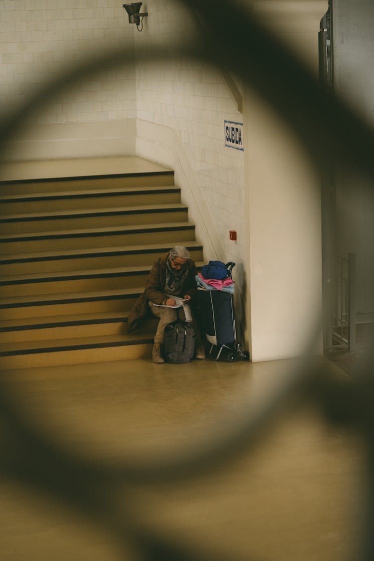 Person Sitting On Stairs