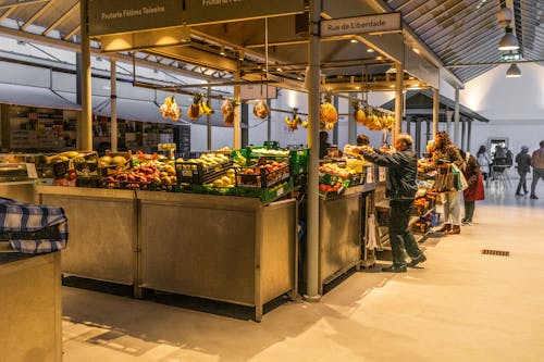 A market with people shopping at the counter