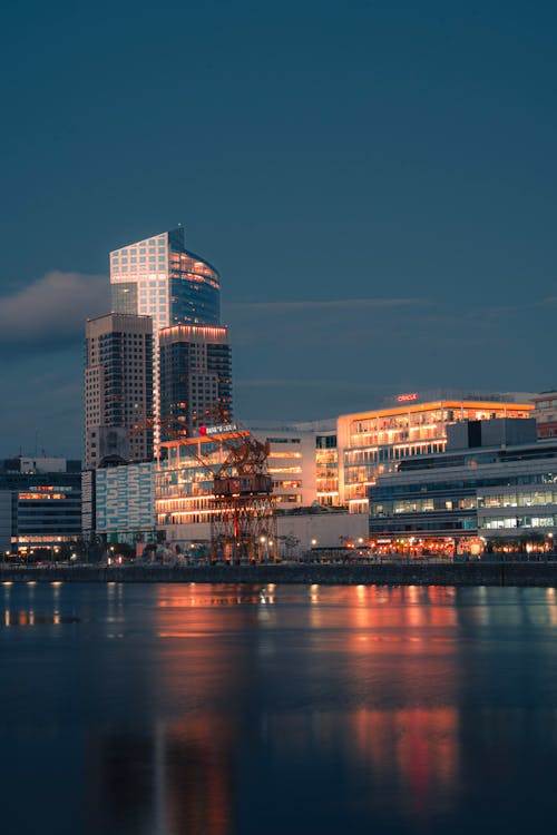 Buildings near River in City at Sunset