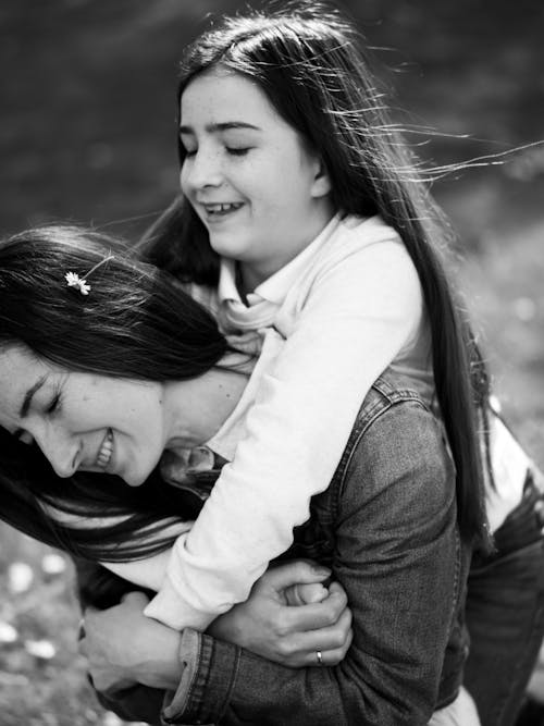 Free Smiling Daughter Hugging her Mother Stock Photo