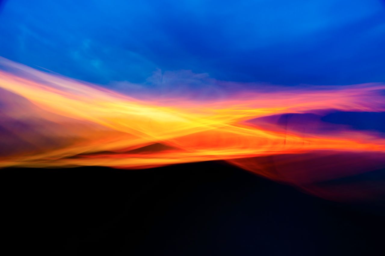 dynamic and vivid abstract depiction of sunset hues blending across th