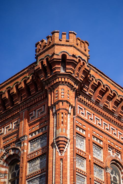 The top of a red brick building with a clock tower