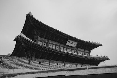 Black and white photo of a building with a roof