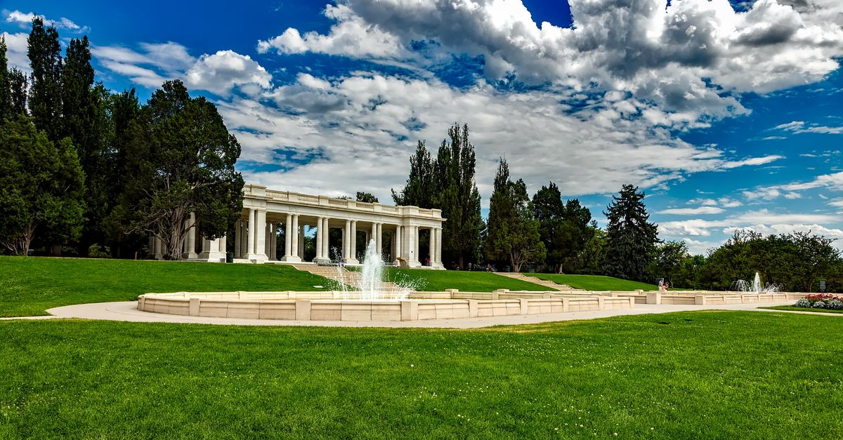 Beautiful pavilion and fountain in Cheesman Park, Denver, under a vibrant summer sky.