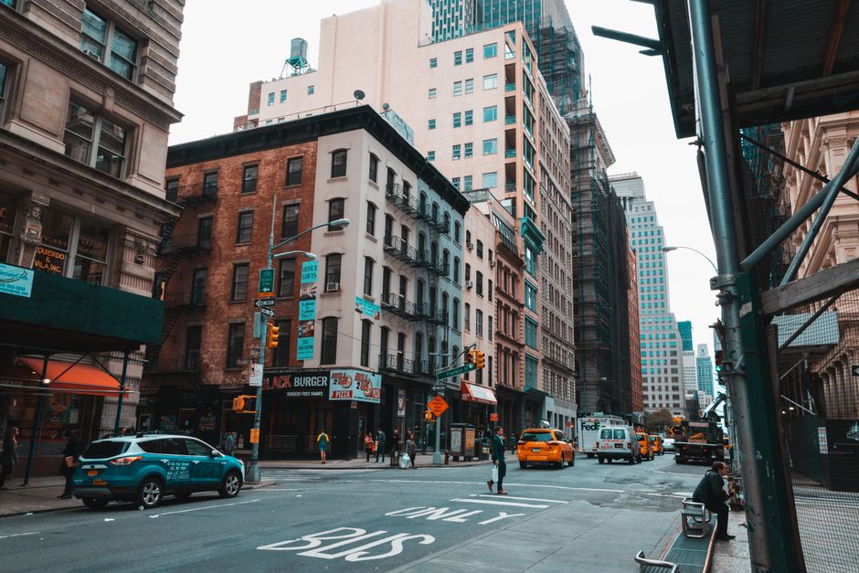 Dynamic street view capturing the vibrant life and historic architecture of a busy urban city.