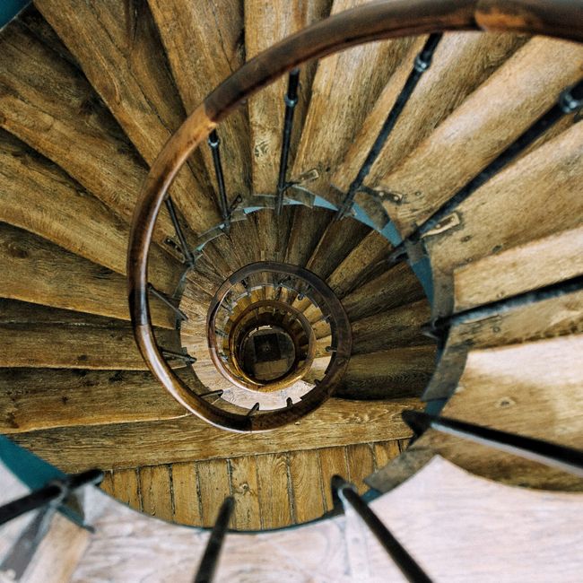 Intricate spiral wooden staircase in Paris provides a mesmerizing architectural view.