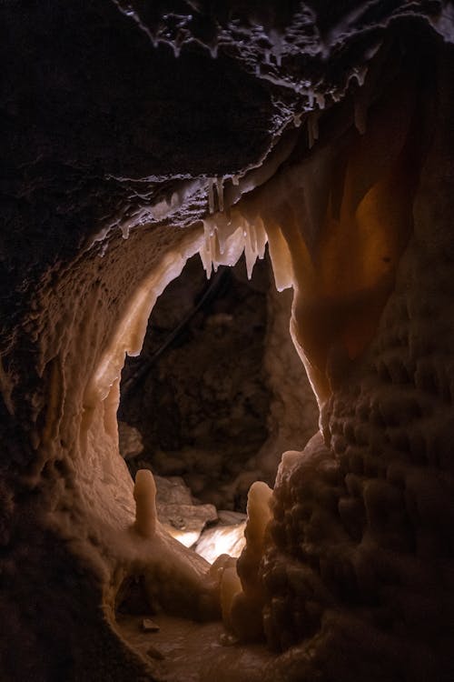 A cave with a light shining through it