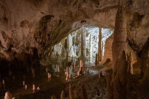 The inside of a cave with many stalagmites