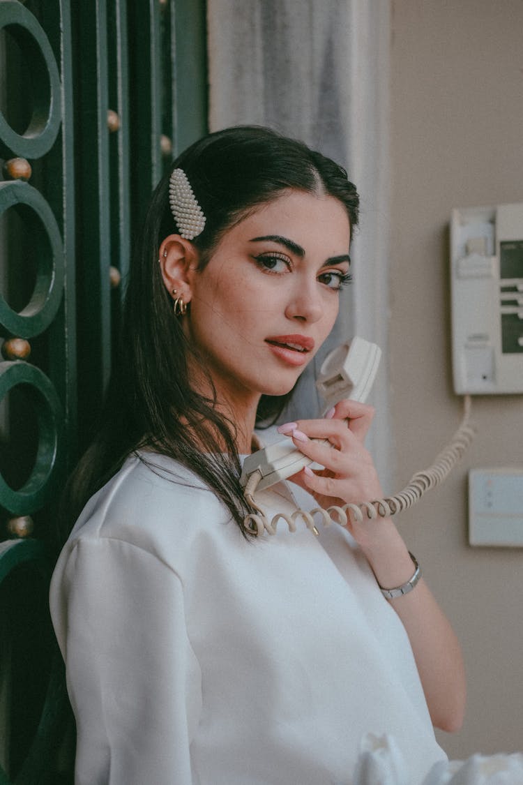 Portrait Of Woman With Intercom Handset