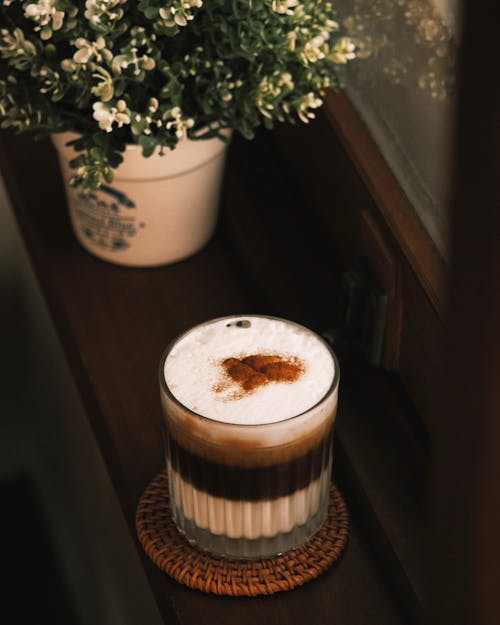 Free A coffee drink with a brown drink on top of a window sill Stock Photo