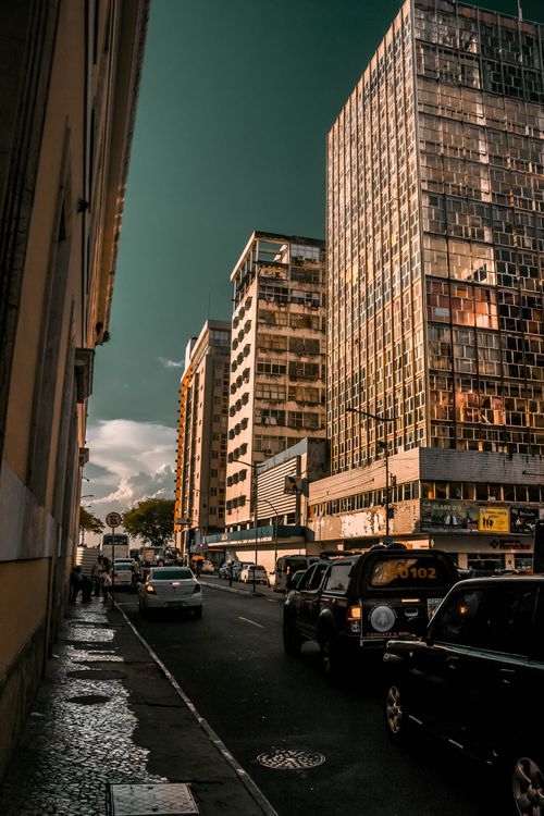 Free A vibrant city street scene with towering skyscrapers and bustling traffic during dusk. Stock Photo