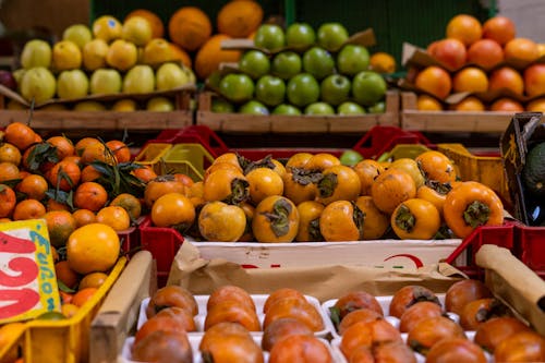 A bunch of oranges and apples in a market