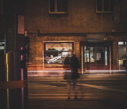 Blurred Woman Standing by Pedestrian Crossing in City