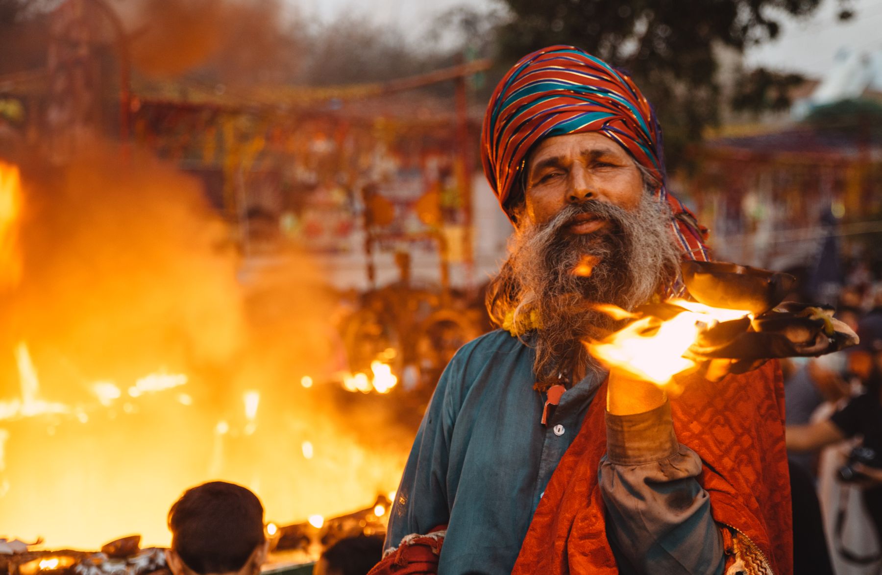 Traditional fire ceremony in Lahore, Pakistan, with a captivating performer.