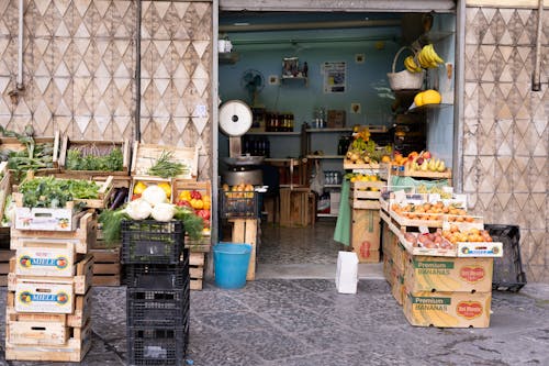 A fruit and vegetable stand with crates and crates