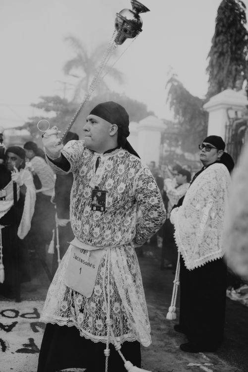 Free A man participates in a spiritual procession wearing traditional attire, holding a censer. Stock Photo