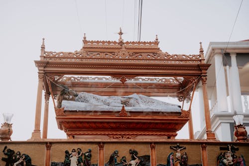 A wooden shrine with statues on top of it