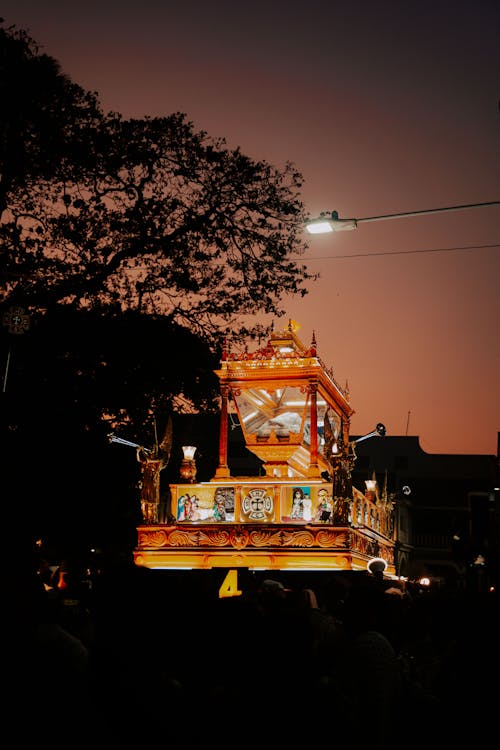 A large golden float is lit up at night