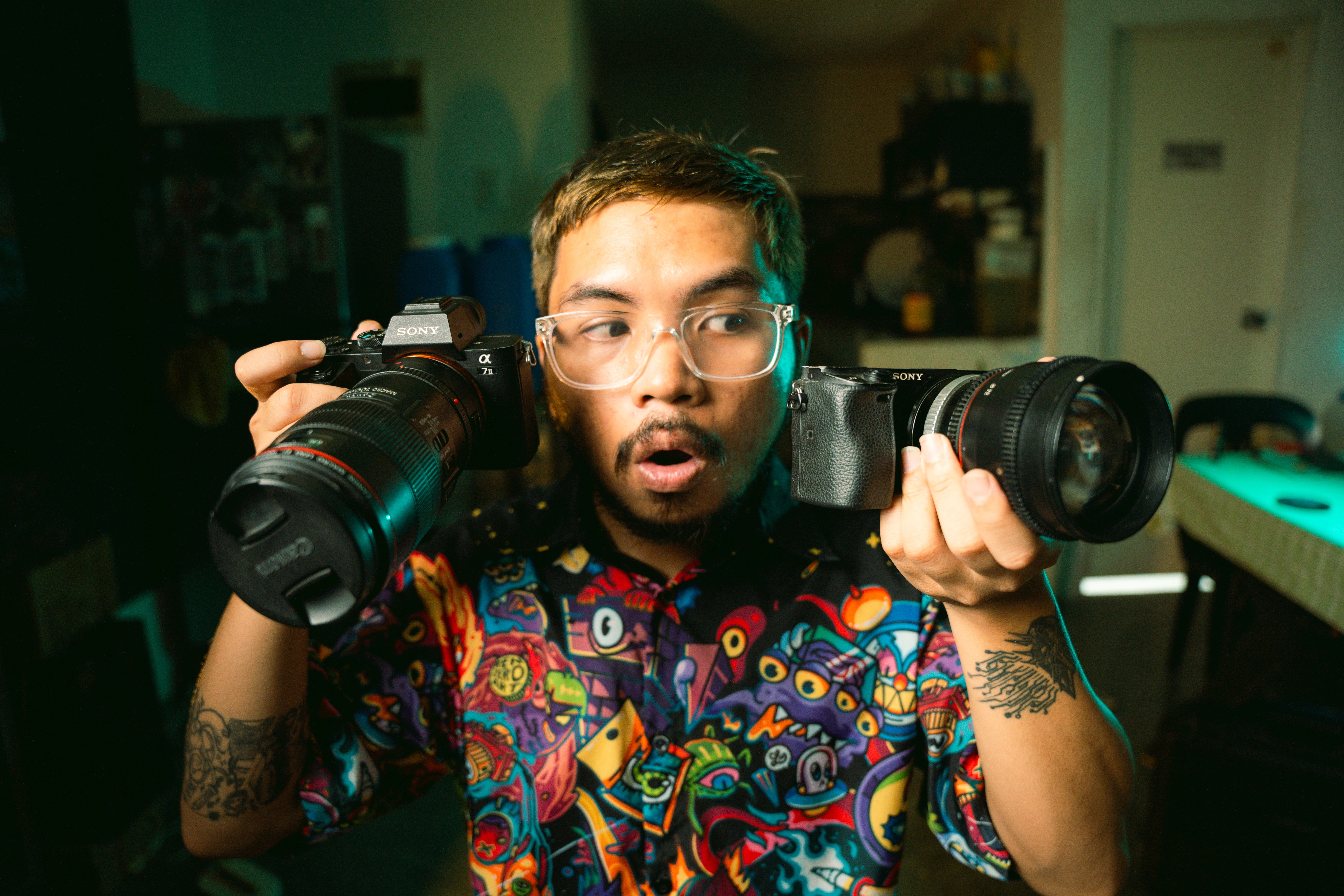 A man holding two cameras in his hands · Free Stock Photo