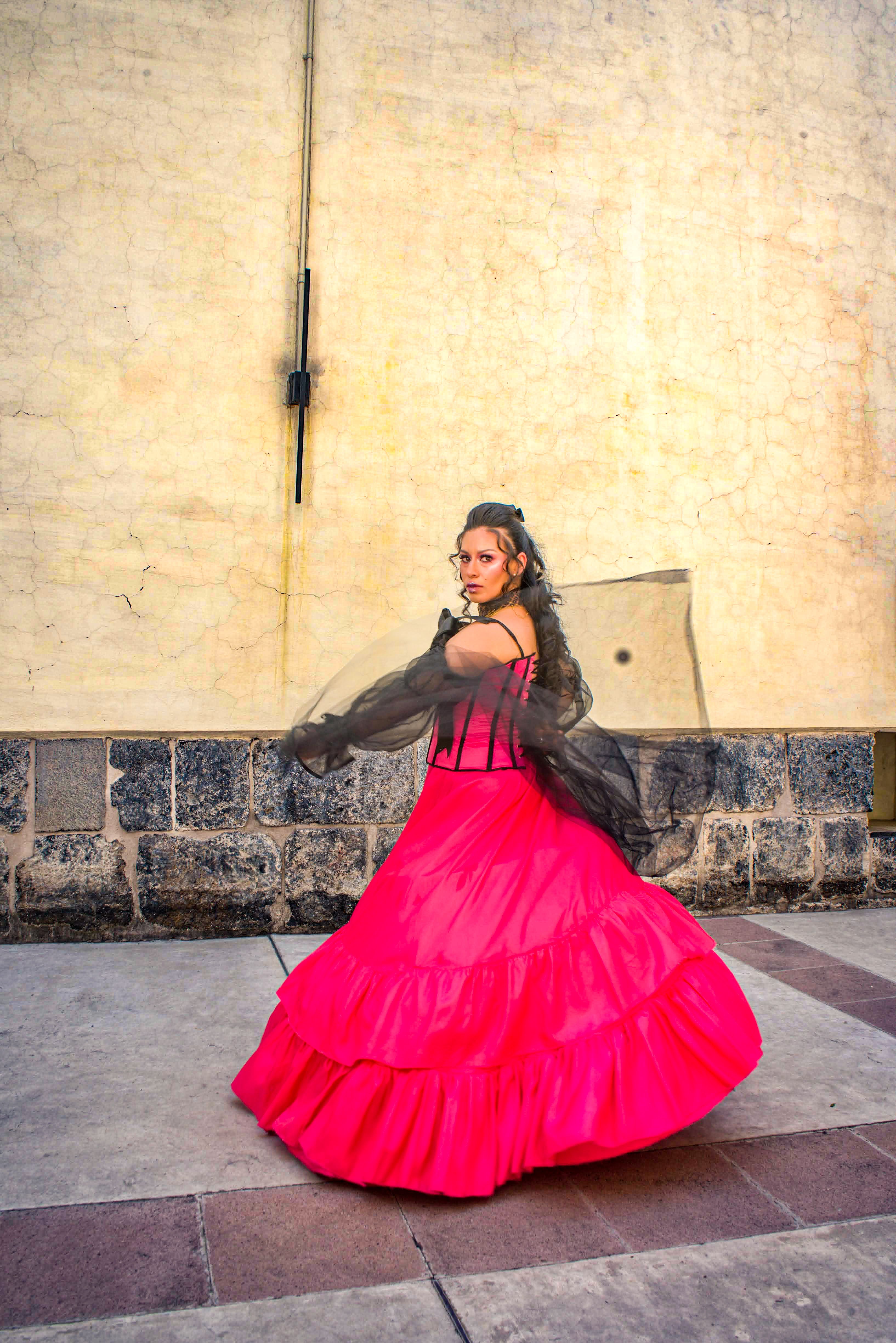 A woman in a pink dress is posing for a photo · Free Stock Photo