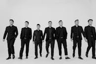 Men in Suits Walking in Black and White