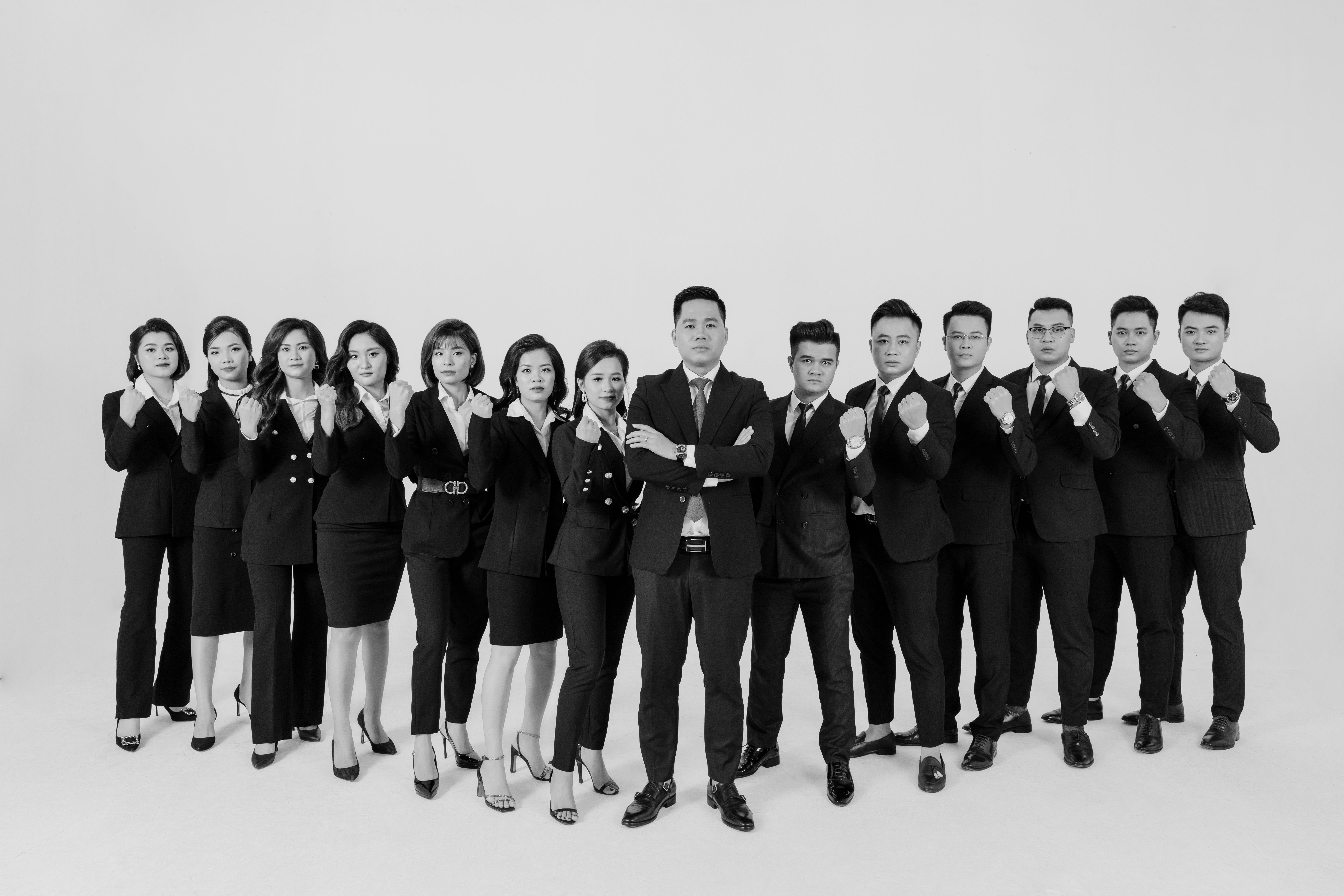 Leader Standing Between Women and Men in Formal Clothing  Free Stock Photo