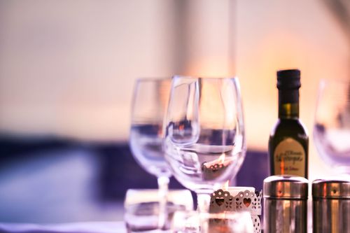 Free Close-up of a sophisticated dining setup featuring wine glasses and a bottle indoors. Stock Photo