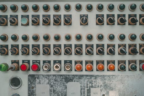 A close up of a control panel with buttons and knobs