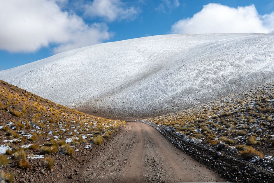 Explore the rugged snow-covered landscapes and dirt roads of Antofagasta de la Sierra in Catamarca, Argentina.