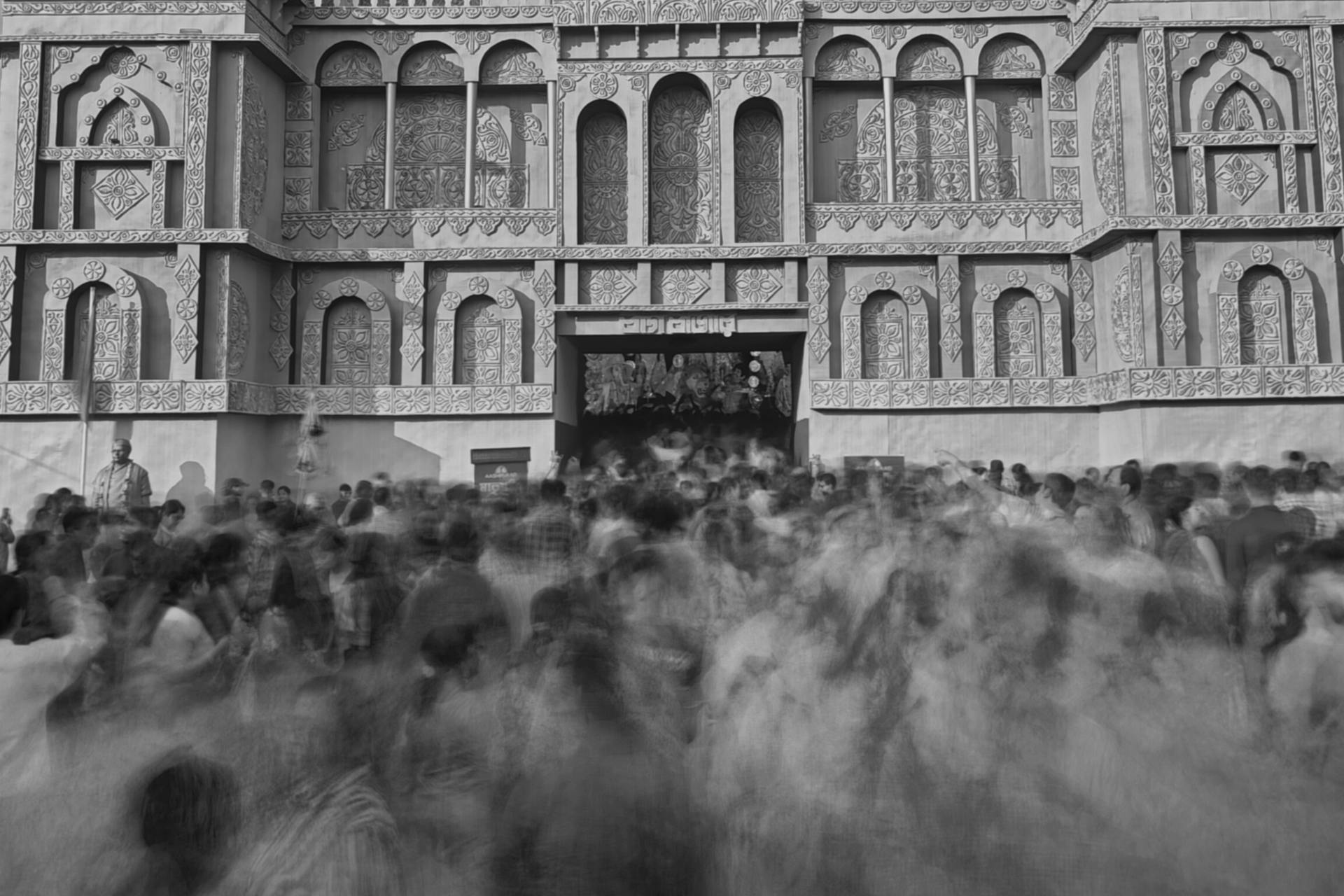 Vibrant Kolkata street scene with crowds embracing architectural heritage.