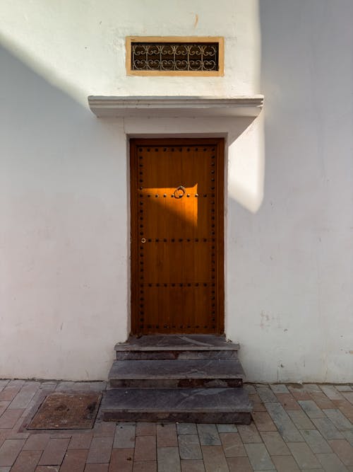 A wooden door with a window in front of it