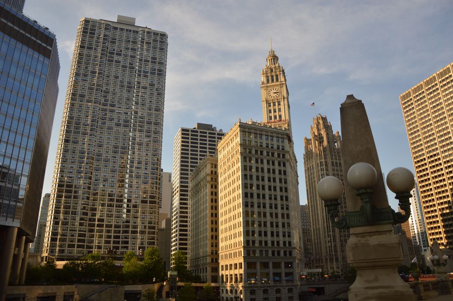 The Wrigley Building's clock tower and the Tribune Tower on North Michigan Avenue in Chicago, lit by low evening sun