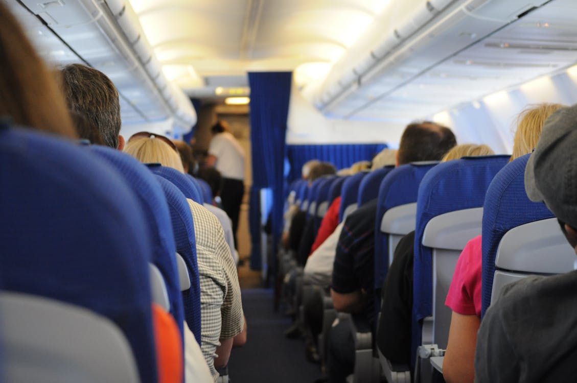 Free People Sitting Inside Airplane Stock Photo