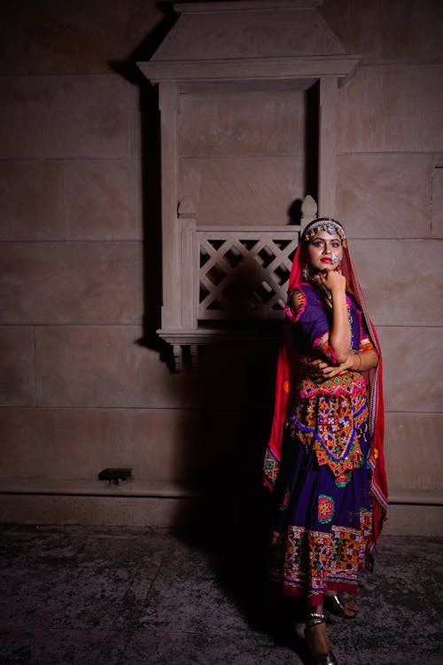 A woman in traditional indian clothing posing for a photo