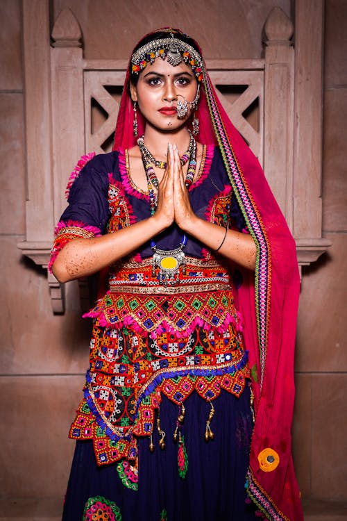 A woman in traditional indian attire is posing for a photo