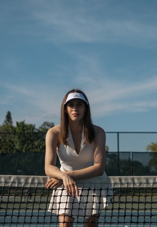 A woman is sitting on the tennis court