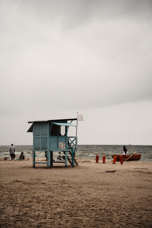A lifeguard stand on the beach with a cloudy sky