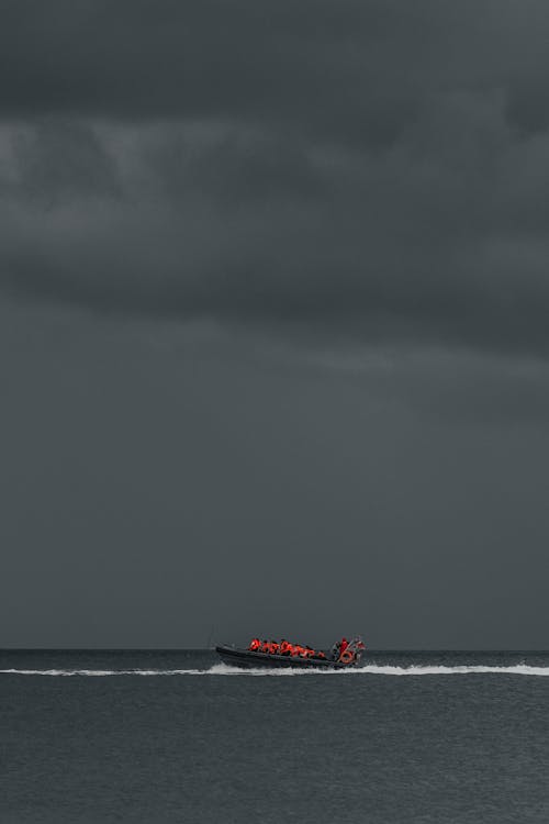 A boat in the ocean under a dark sky