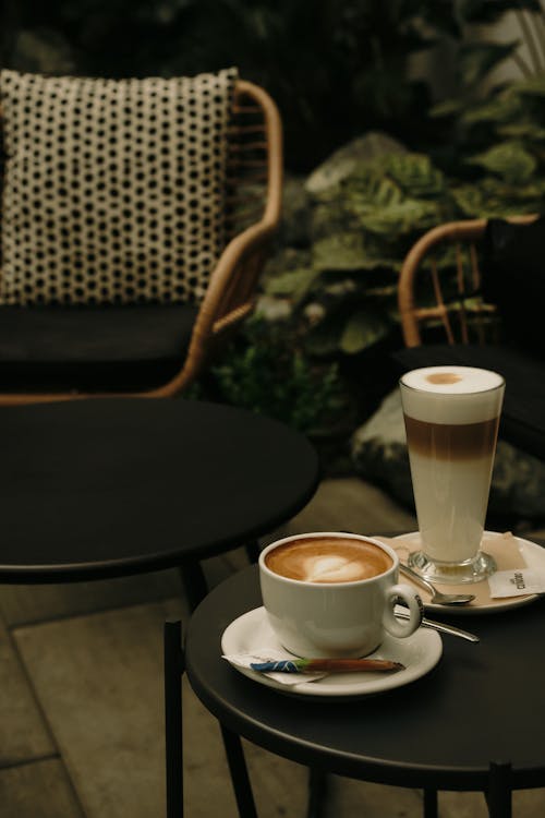 A cup of coffee and a cup of tea on a table