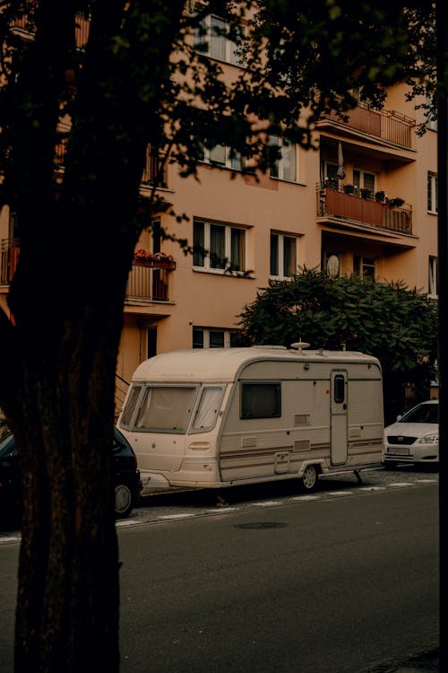 A camper parked in front of a building